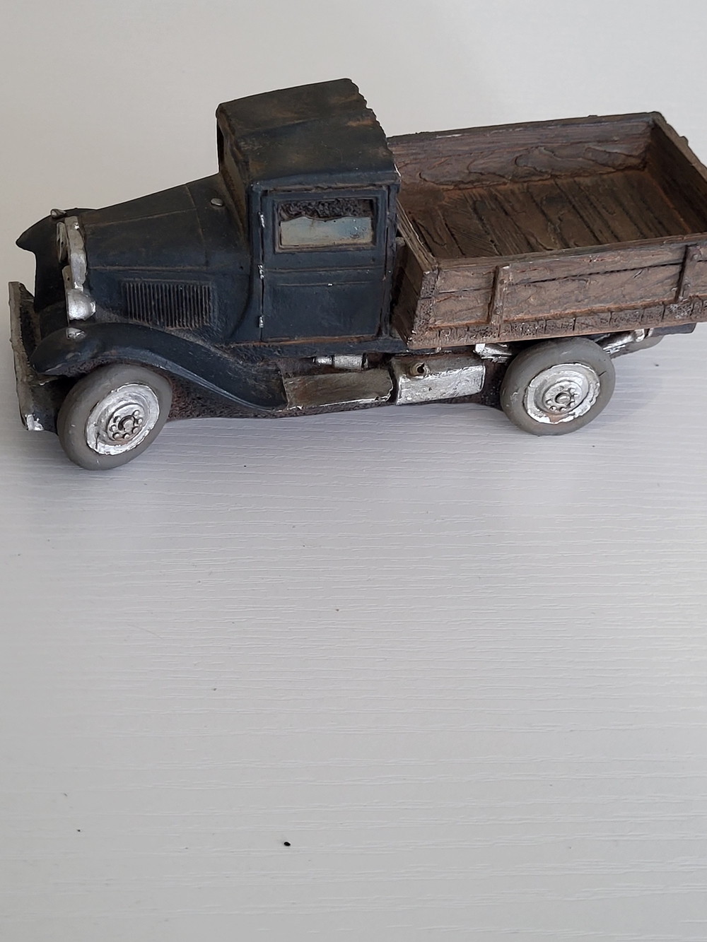 vintage-style decorative figurine of an old farm or delivery truck
